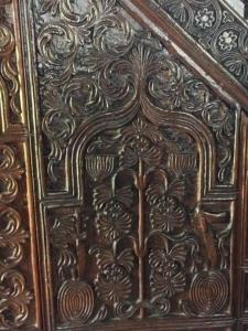 Detail from a wood panel in a tiny mosque on the Georgian border - this image depicts a menorah in honor of Judaism. (Image by Liz Cameron)